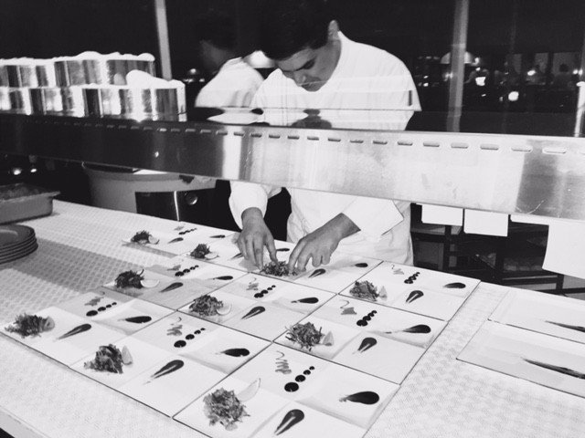 Chef Sameer Sehgal finishing plates on the pass