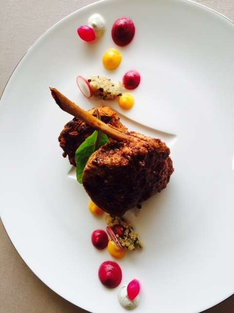 Spiced lamb cutlet with berries and coloured sauces