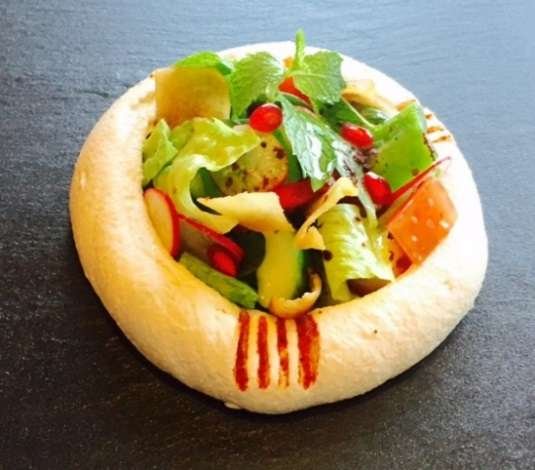 Hummus with fattoush in a bread bowl