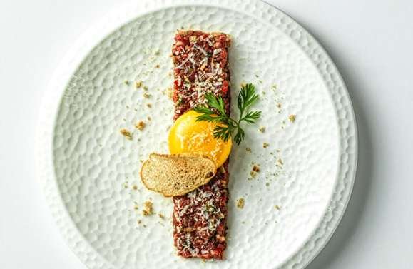 Steak tartare with a poached egg yolk