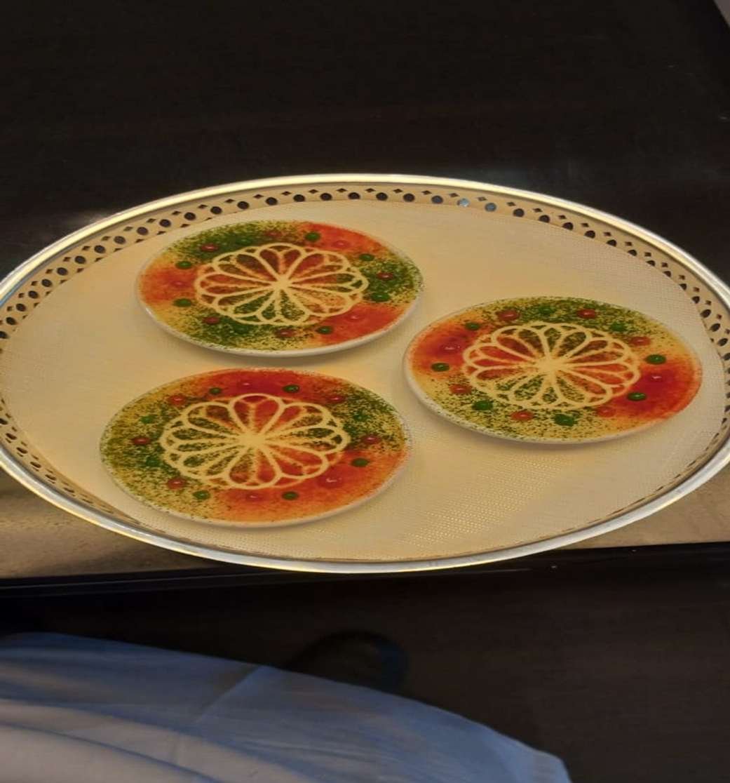 Three decorated afternoon tea discs on a silver tray