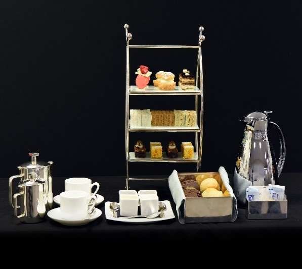 Afternoon tea service with silver and a three-tier stand