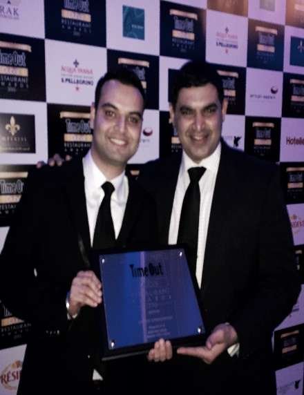 Chef Sameer Sehgal with a colleague holding a Time Out Dubai award