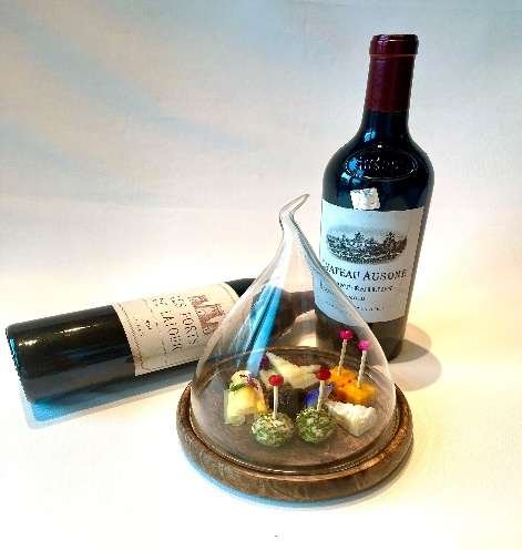 Canapés under a glass cloche with Bordeaux wine